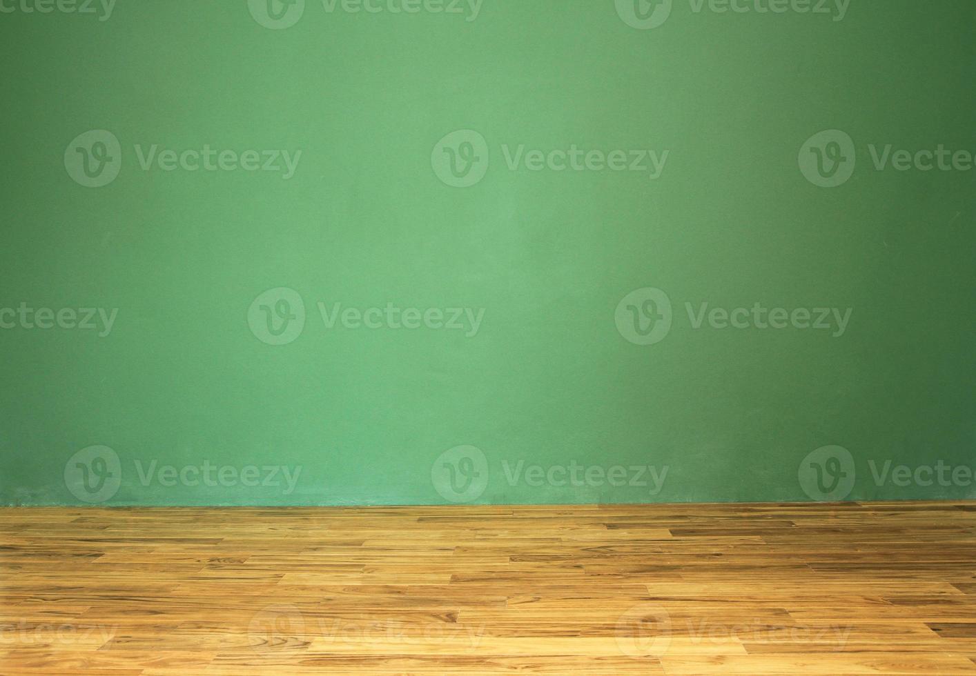 Green wall and solid wood floor in empty room photo