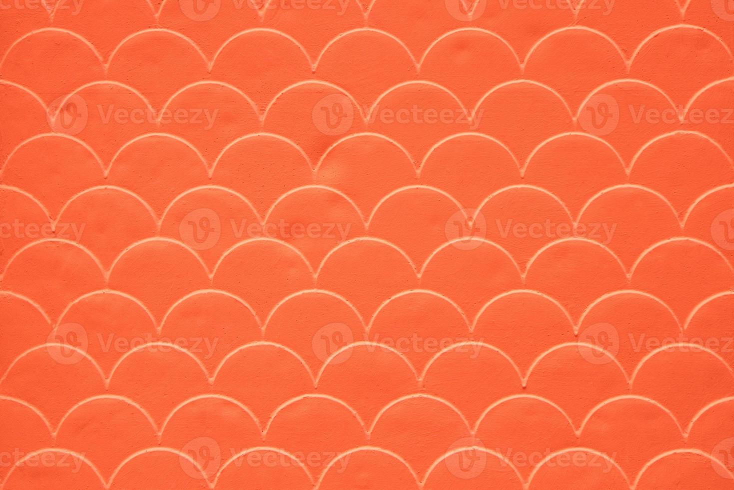 Orange fish scale seamless pattern on decorated cement wall photo