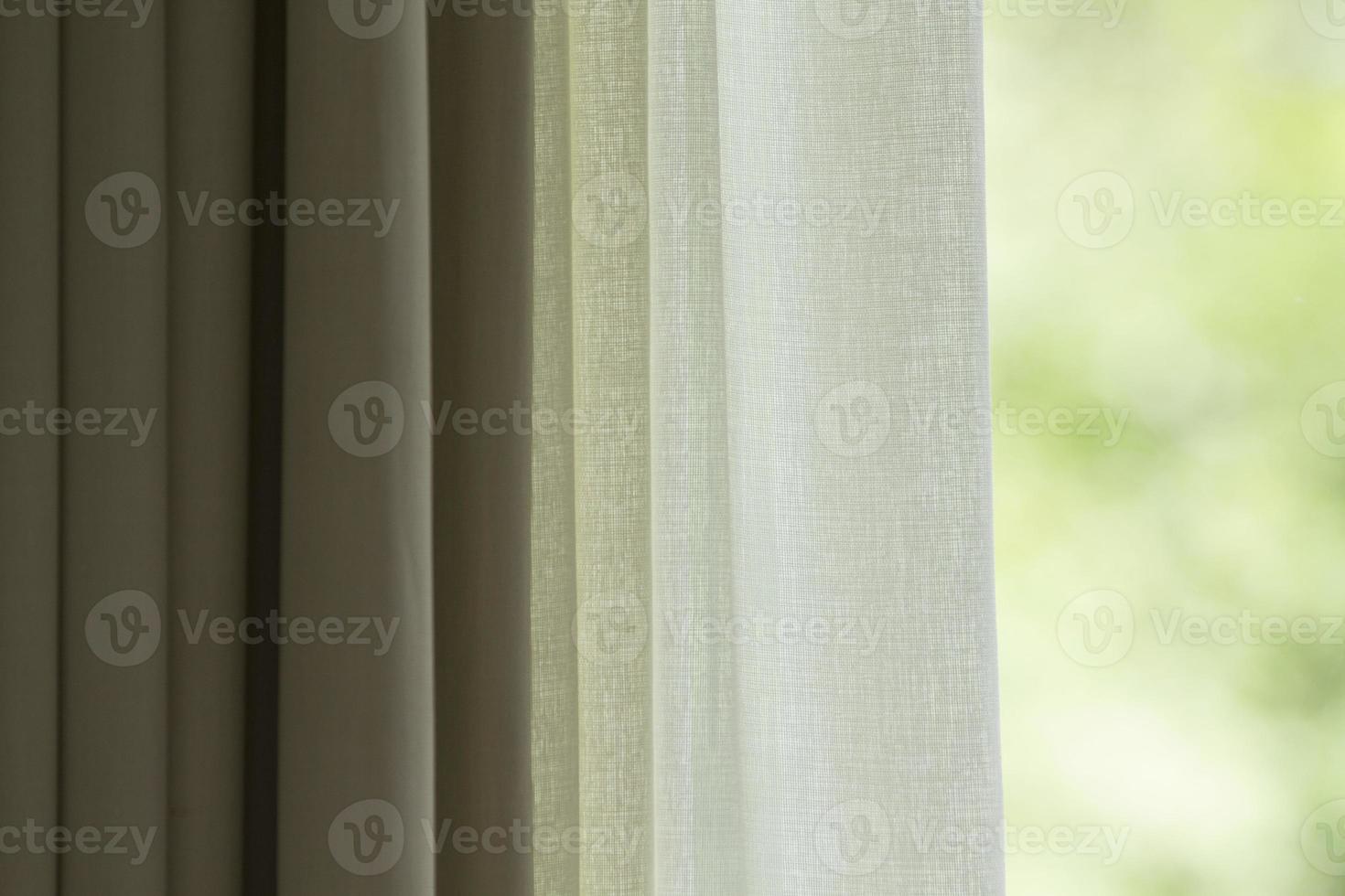 Curtain with window view from green tree background photo