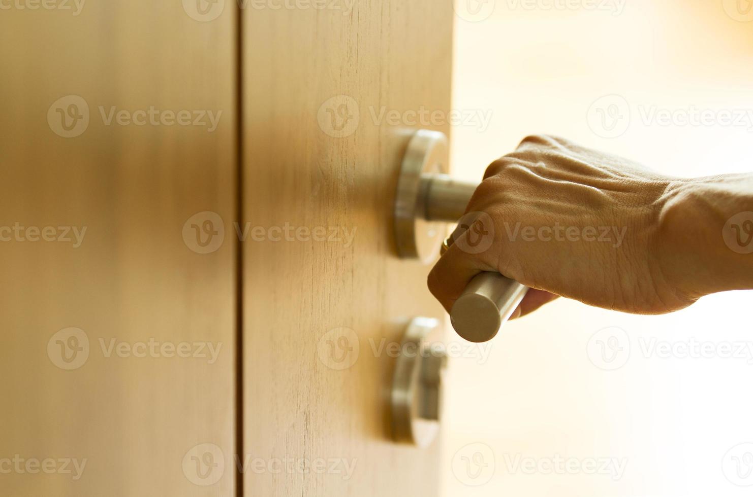 Hand opening wooden door photo