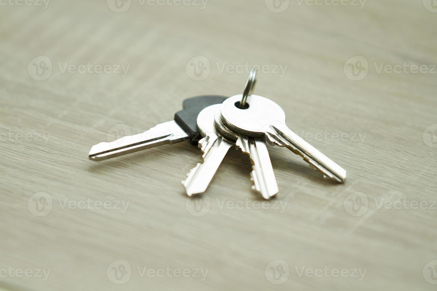 A bunch of keys on wooden background photo