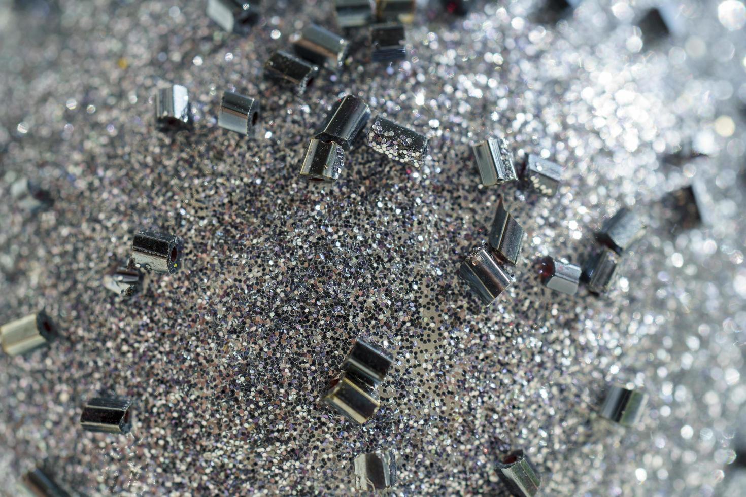 Shiny grey surface with sequins and close-up beads photo