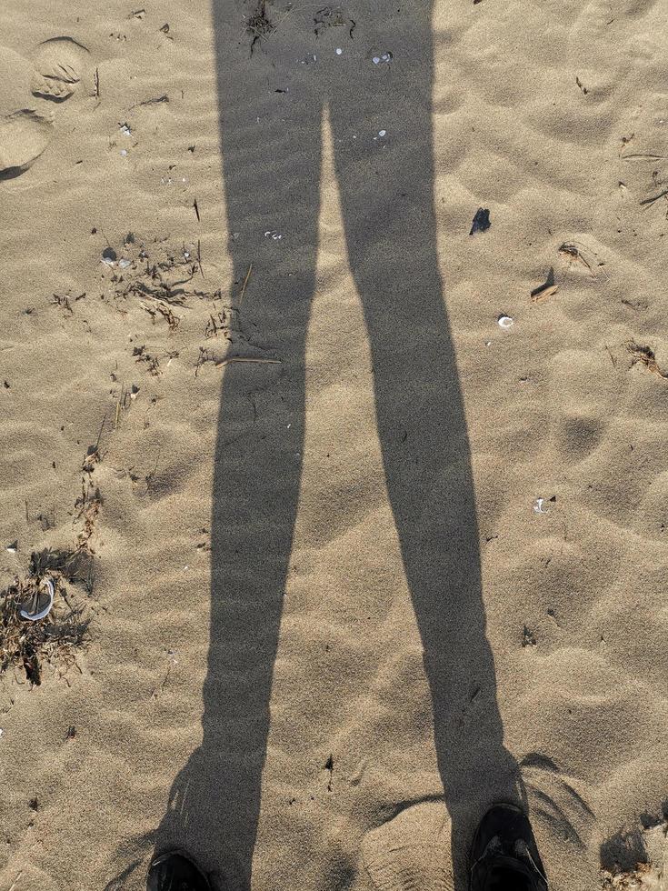 Silhouette of a man on a sandy background of the beach photo