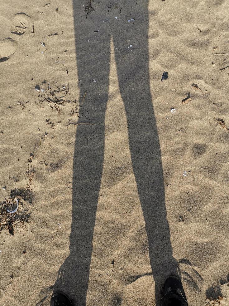 Silhouette of a man on a sandy background of the beach photo