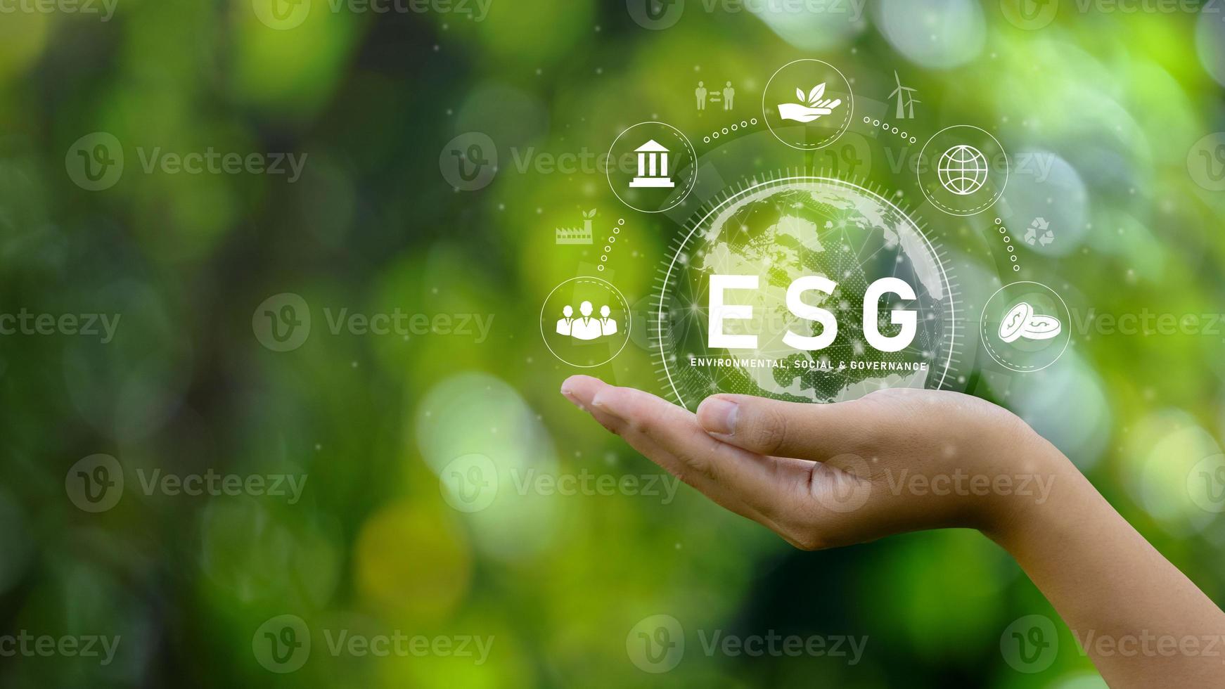 ESG icon concept. Environment in renewable hands. Nature, earth, society and governance SG in sustainable business on networked connections on green background. environmental icon photo