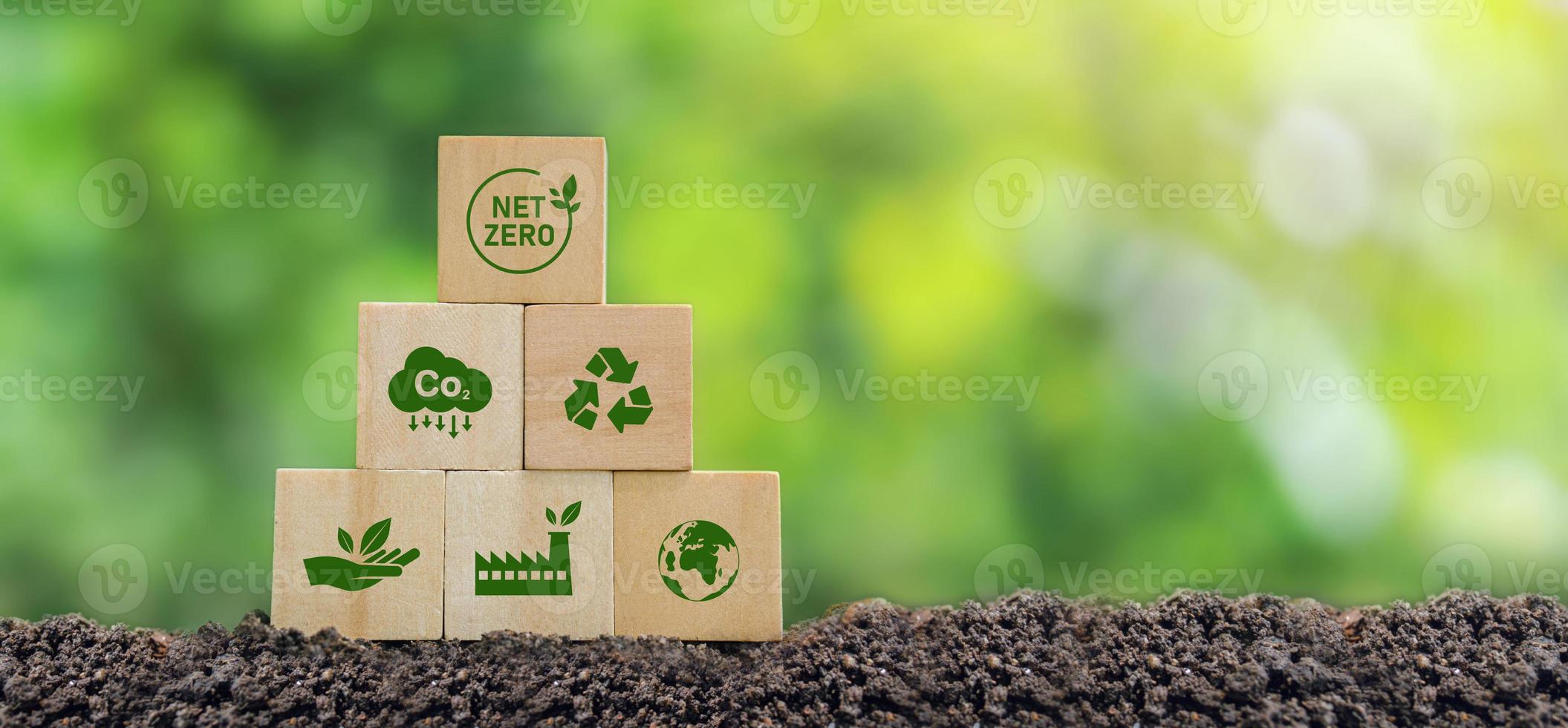 Carbon neutral and net zero concept natural environment Climate-neutral long-term strategy greenhouse gas emissions targets Wooden block with green net center icon and world save icon photo