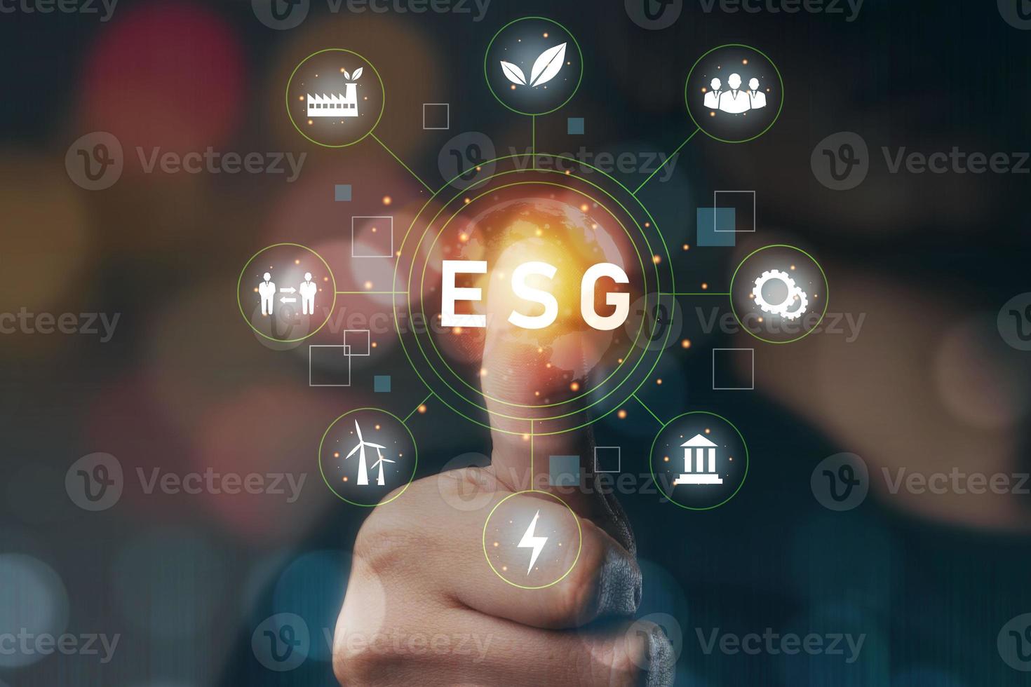 Hand touch of thumb. ESG icon concept in hand for environment, technology, society and governance in sustainable and ethical business on networked connections on green background. photo