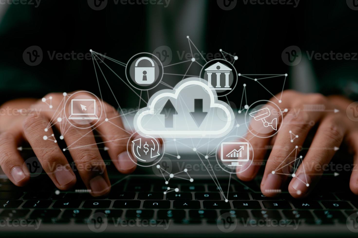 A man uses a laptop that displays a schematic of cloud computing. Data storage, networking, and internet service as they relate to cloud technology. photo