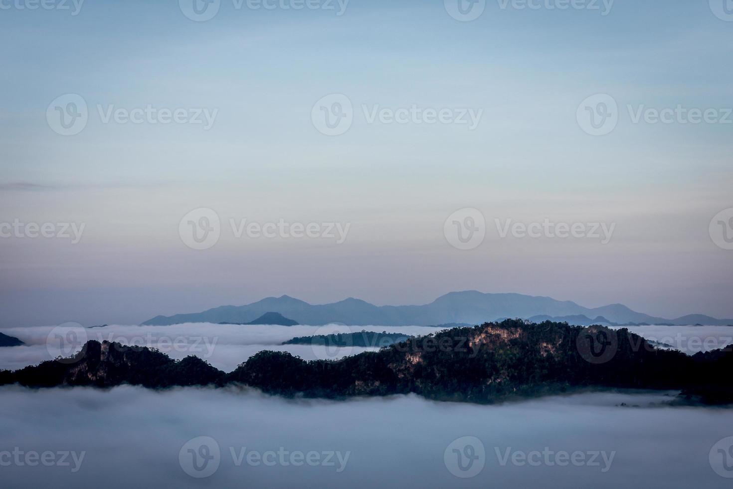 Mist and morning light on a large mountain viewpoint photo