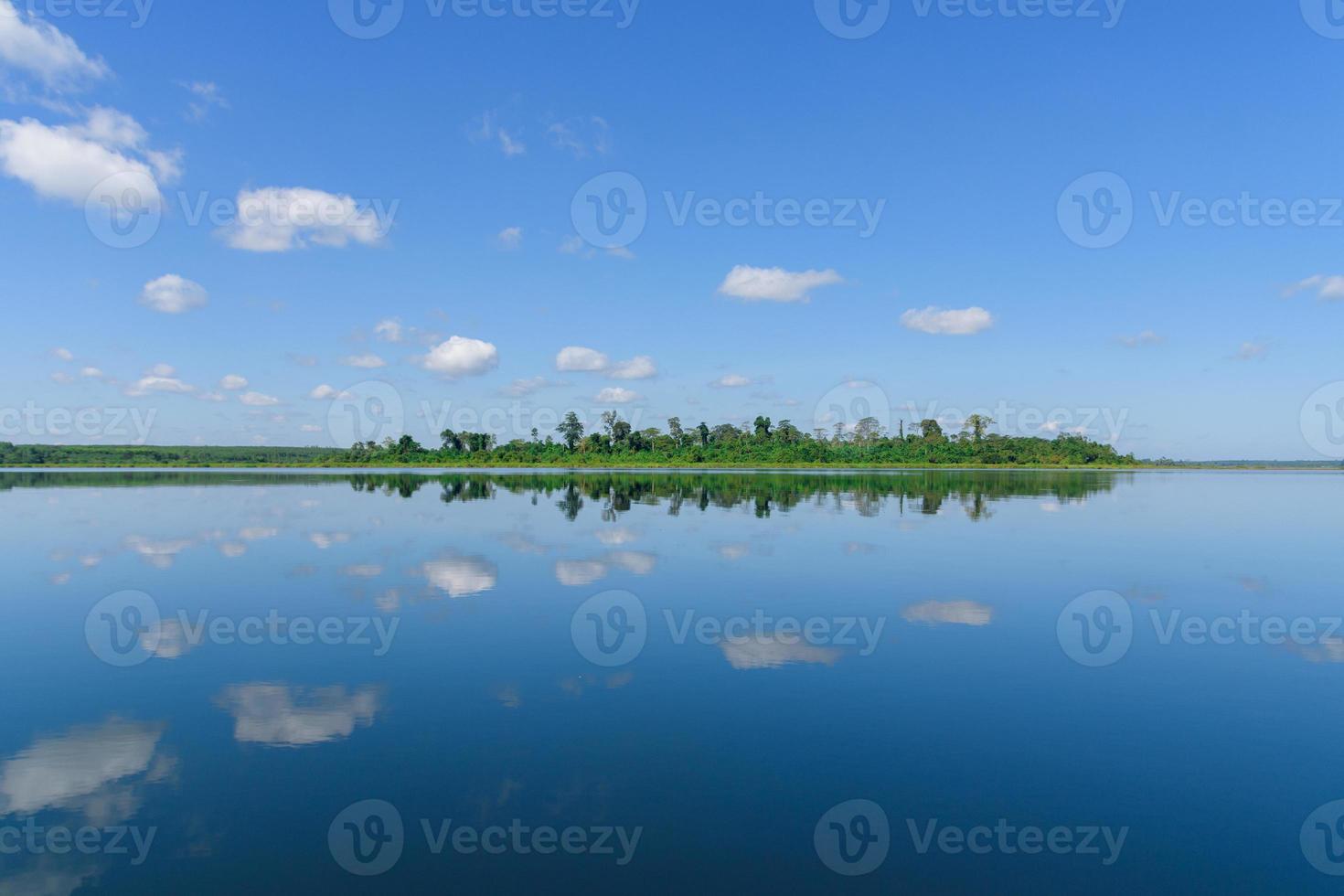 Large island in the lake. There is a beautiful cloud reflecting on the water At  Bueng Kan Province of Thailand photo