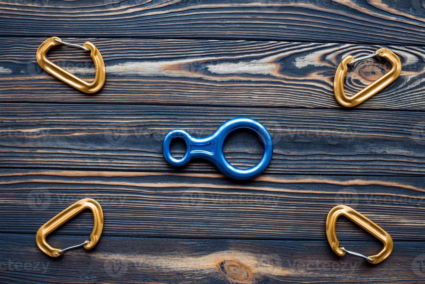 Conception of art and creativity. Isolated photo of climbing equipment. Parts of carabiners lying on the wooden table