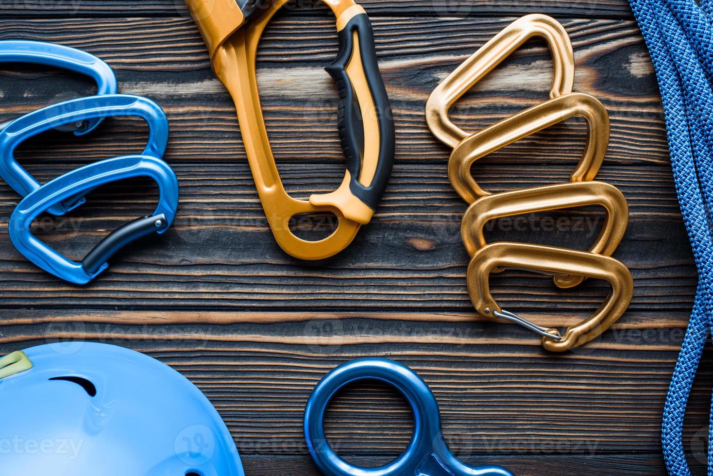 Little but strong. Isolated photo of climbing equipment. Parts of carabiners lying on the wooden table
