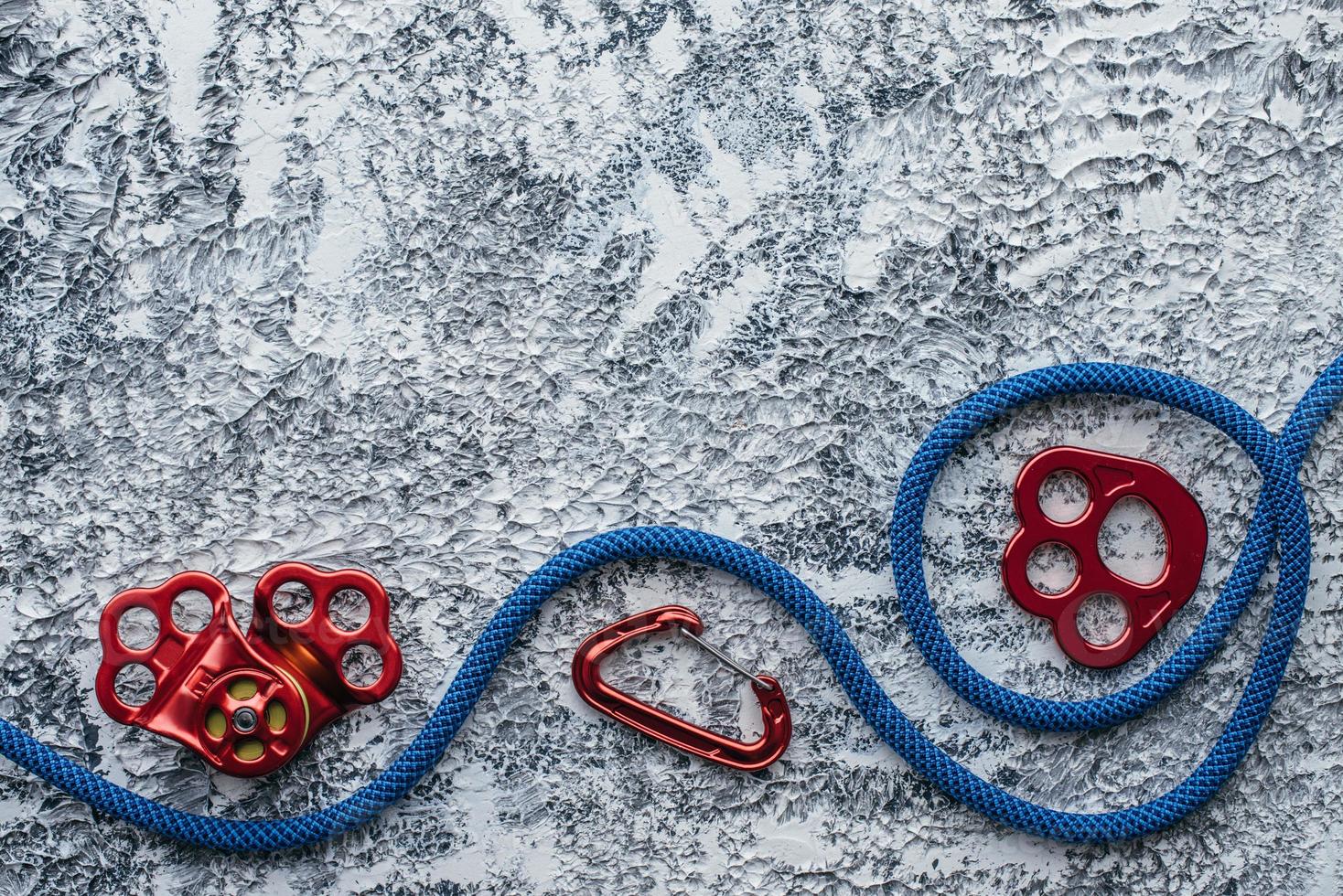 Gear of technician. Isolated photo of climbing equipment. Part of carabiner lying on the white and grey colored table