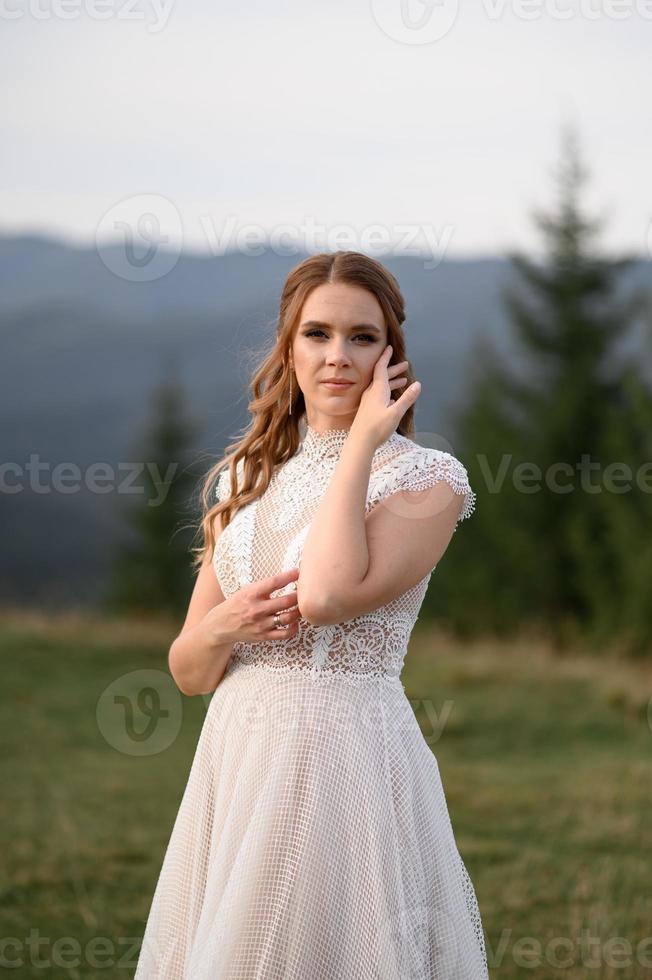 happy stylish bride and groom running and having fun in mountains on summer sunny day photo