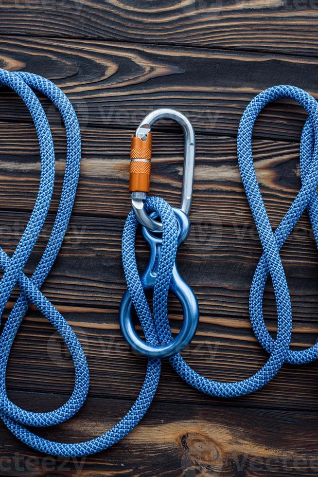 Conception of trust. Isolated photo of climbing equipment. Parts of carabiners lying on the wooden table