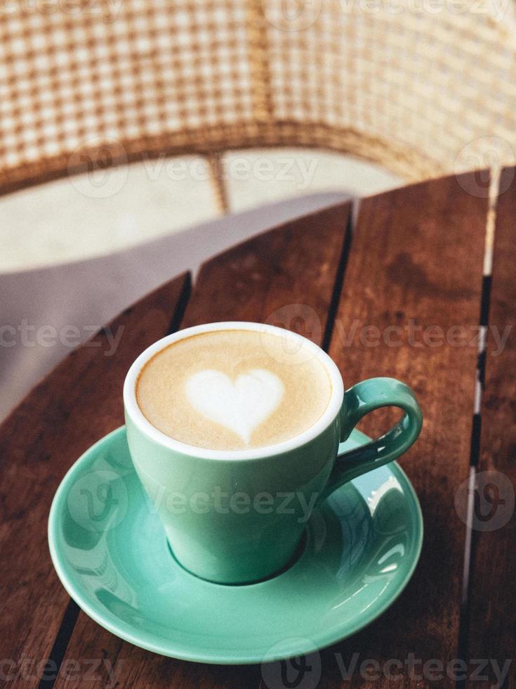 A cup of hot latte coffee on the table for breakfast photo