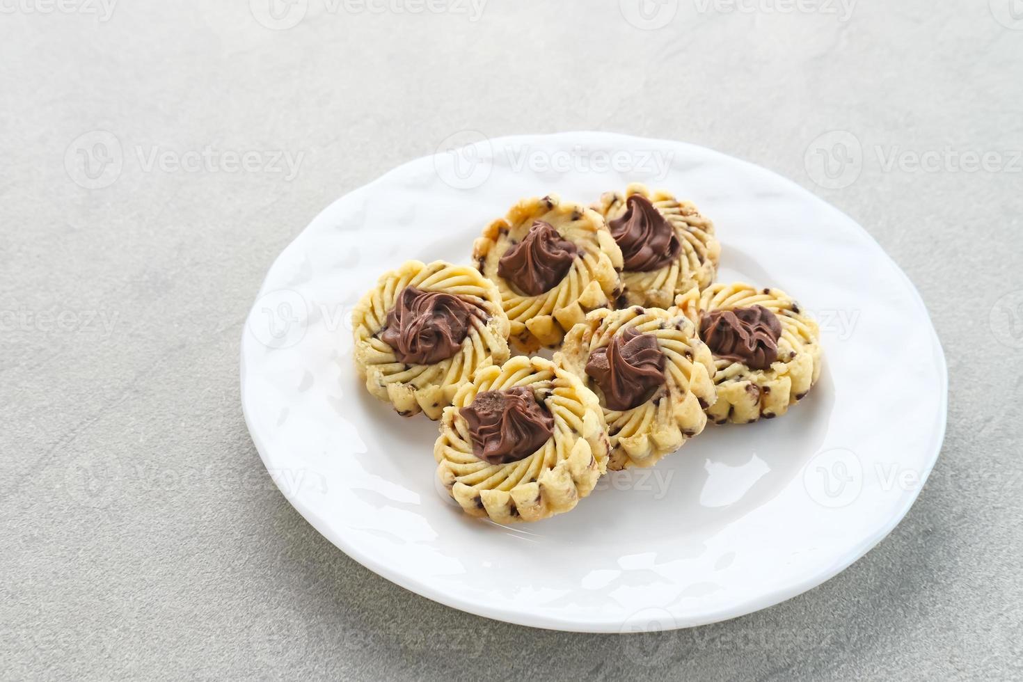 Nutella Butter Cookies, popular cookies for Eid celebrations in Indonesia. Served in white plate on grey background photo