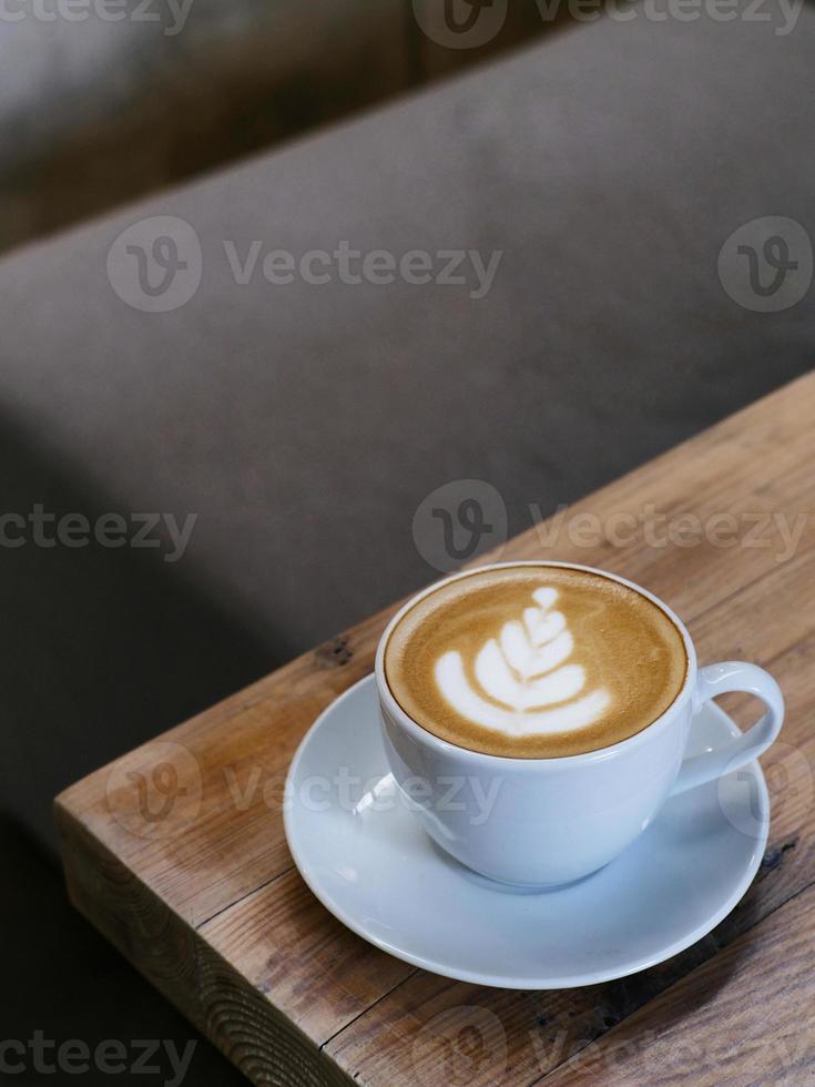 A cup of hot latte coffee on the table for breakfast photo