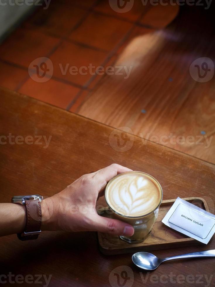 A cup of hot latte coffee on the table for breakfast photo