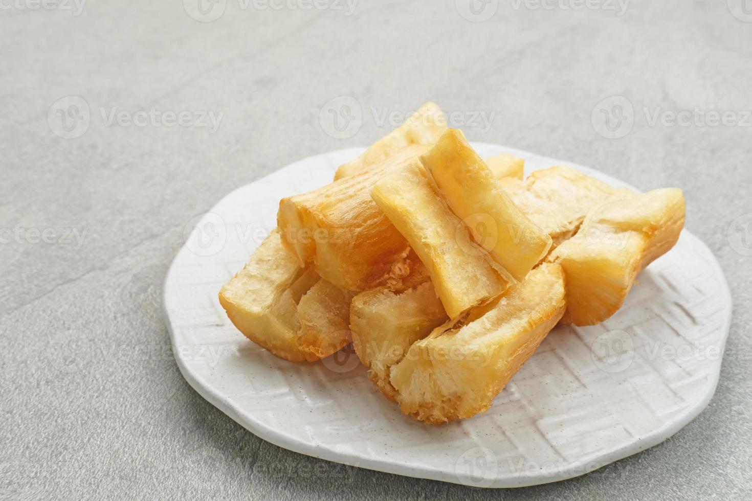Fried casava or singkong goreng is Indonesian traditional food. Selected focus. photo