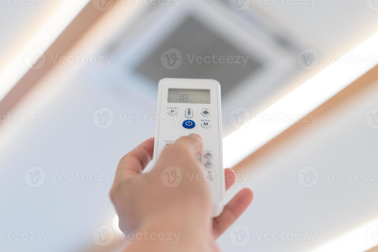 Focus on Power button of Air Conditioner Remote control, to open and turn off it at ceilling of seminar hall. photo