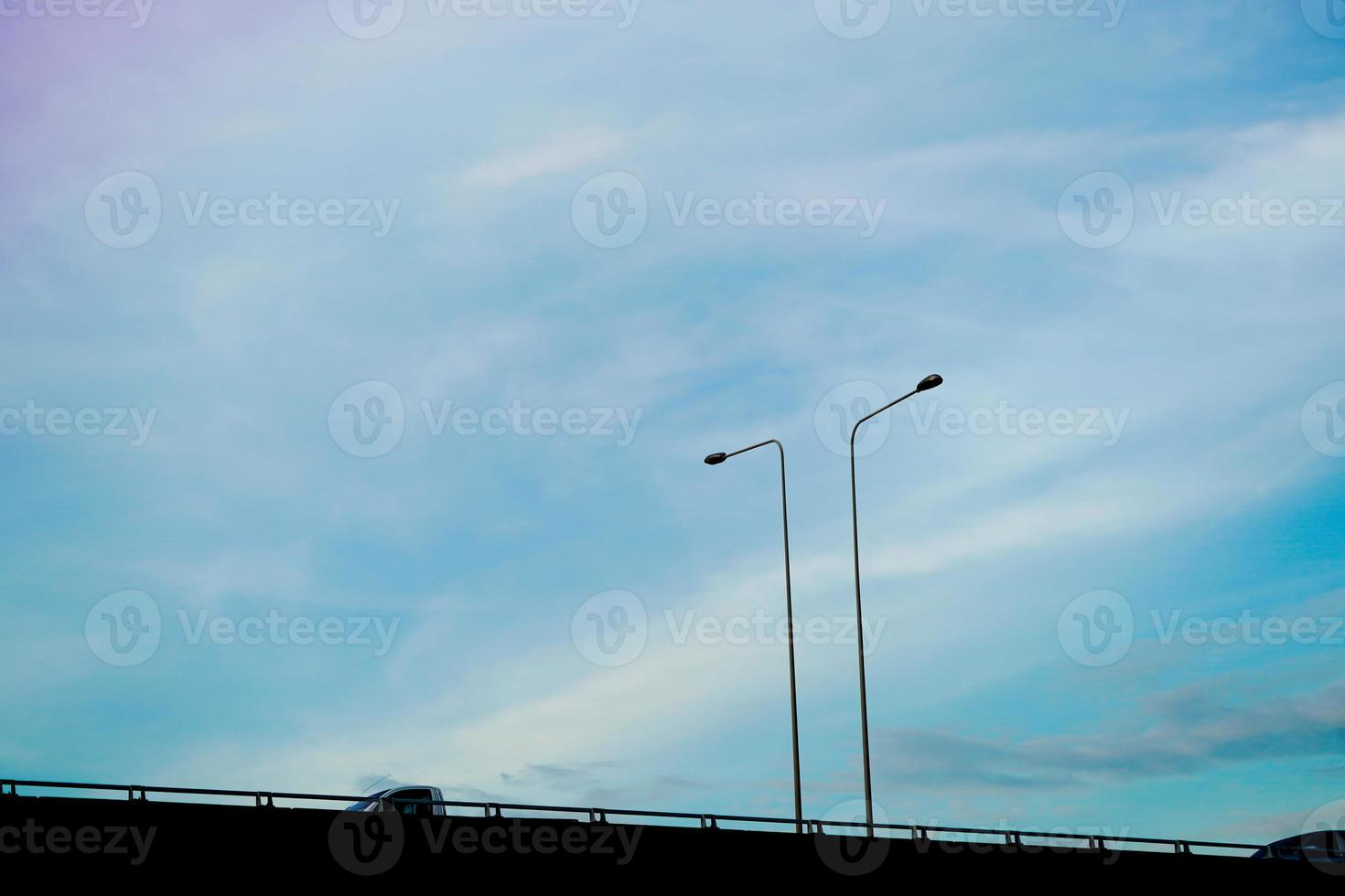 Clearly beautiful blue sky with expressway tuck and lamp post. photo