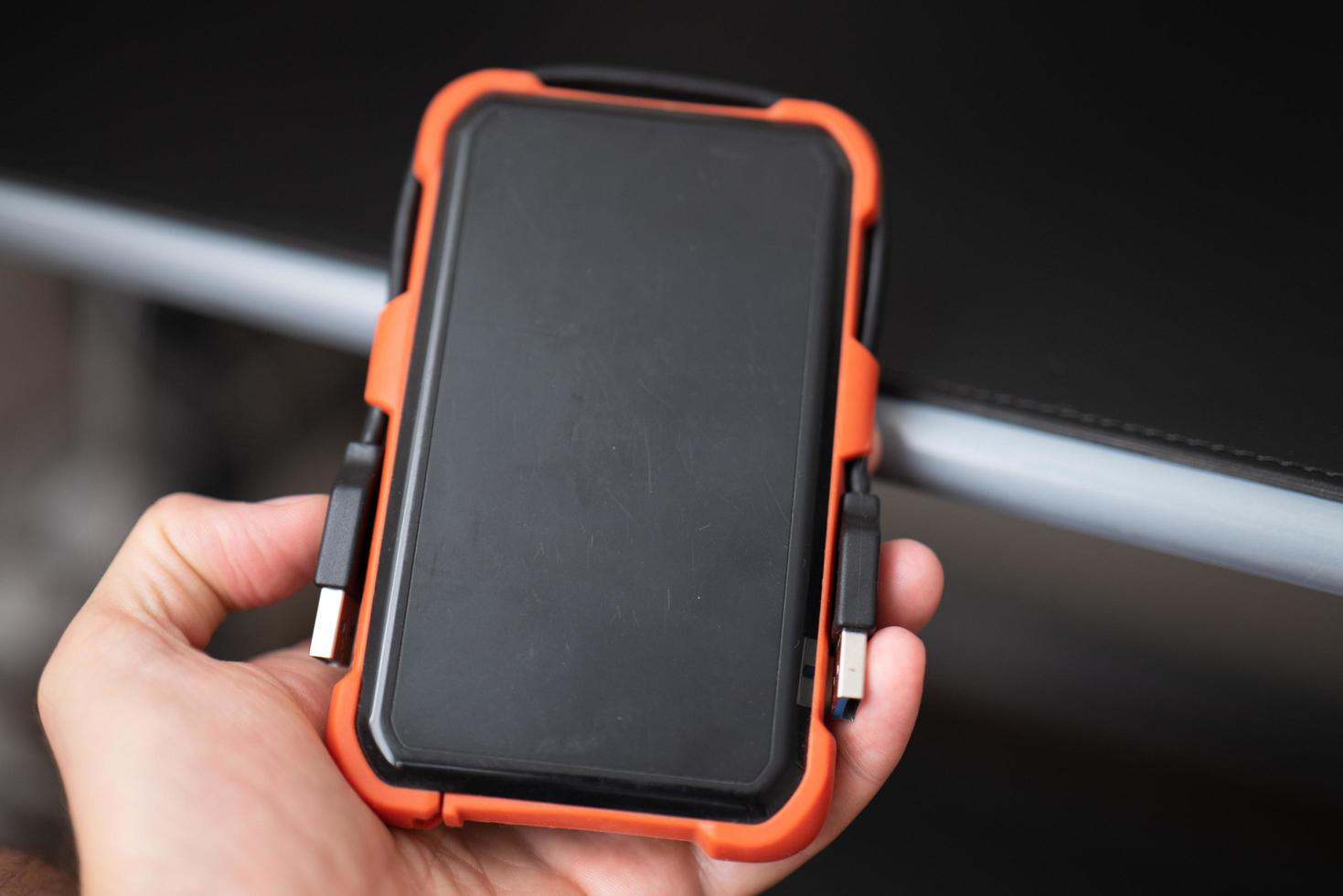 External hard drive in male hand photo