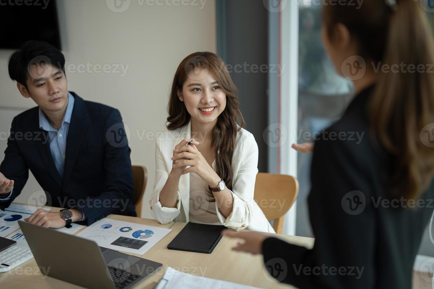 Diverse business workgroup designers team with asian woman leader discuss paperwork financial report statistical data, forecasting working on common project. Brainstorm, briefing activity concept photo