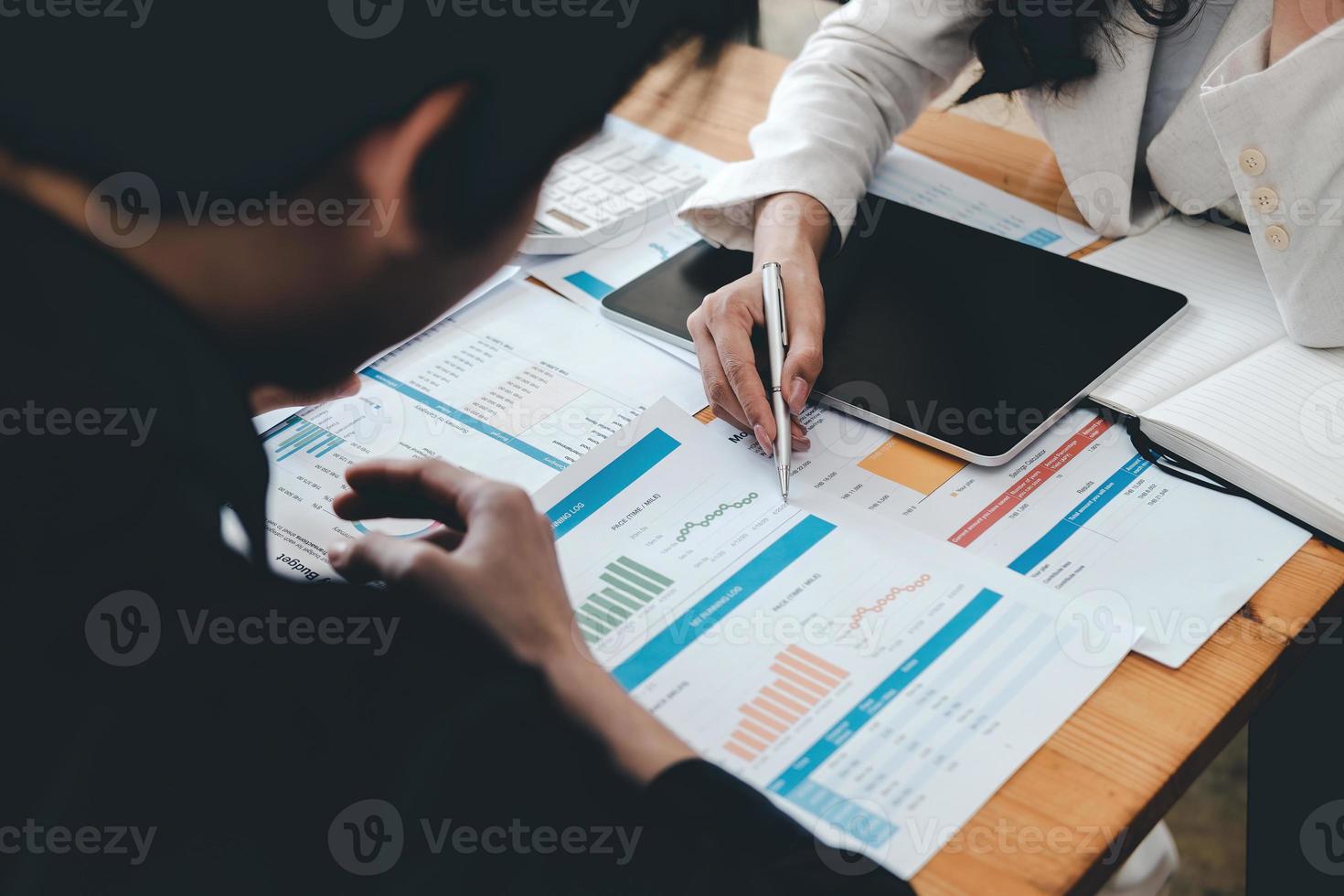 Business team support and meeting concept. Group of Investor working and pointing at financial paperwork Finance task. photo