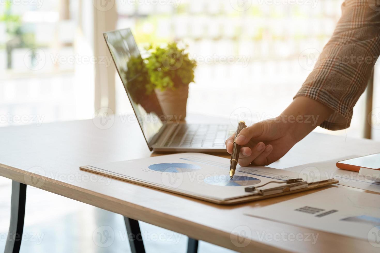Financial Business woman analyze the graph of the company's performance to create profits and growth, Market research reports and income statistics, Financial and Accounting concept photo