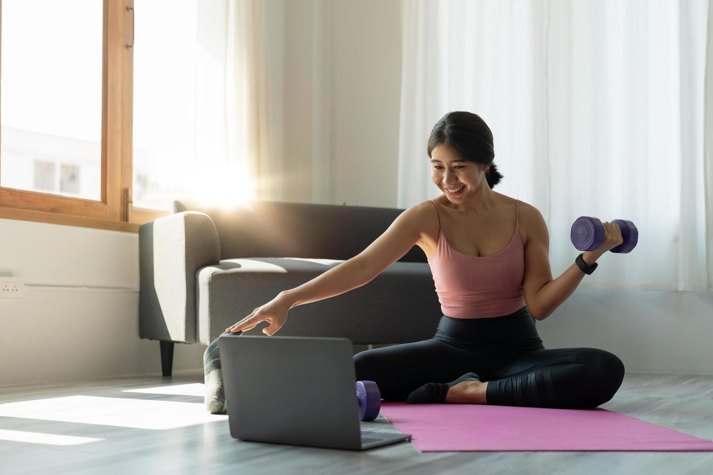 Young woman is exercising yoga at home. Fitness, workout, healthy living and diet concept photo