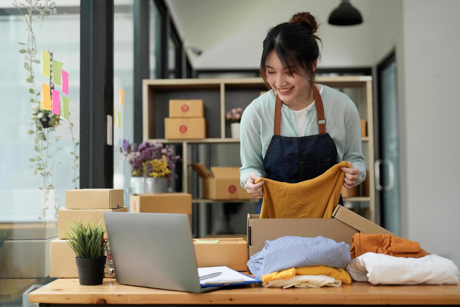 Young asian startup entrepreneur small business owner working at home, packaging and delivery situation. photo