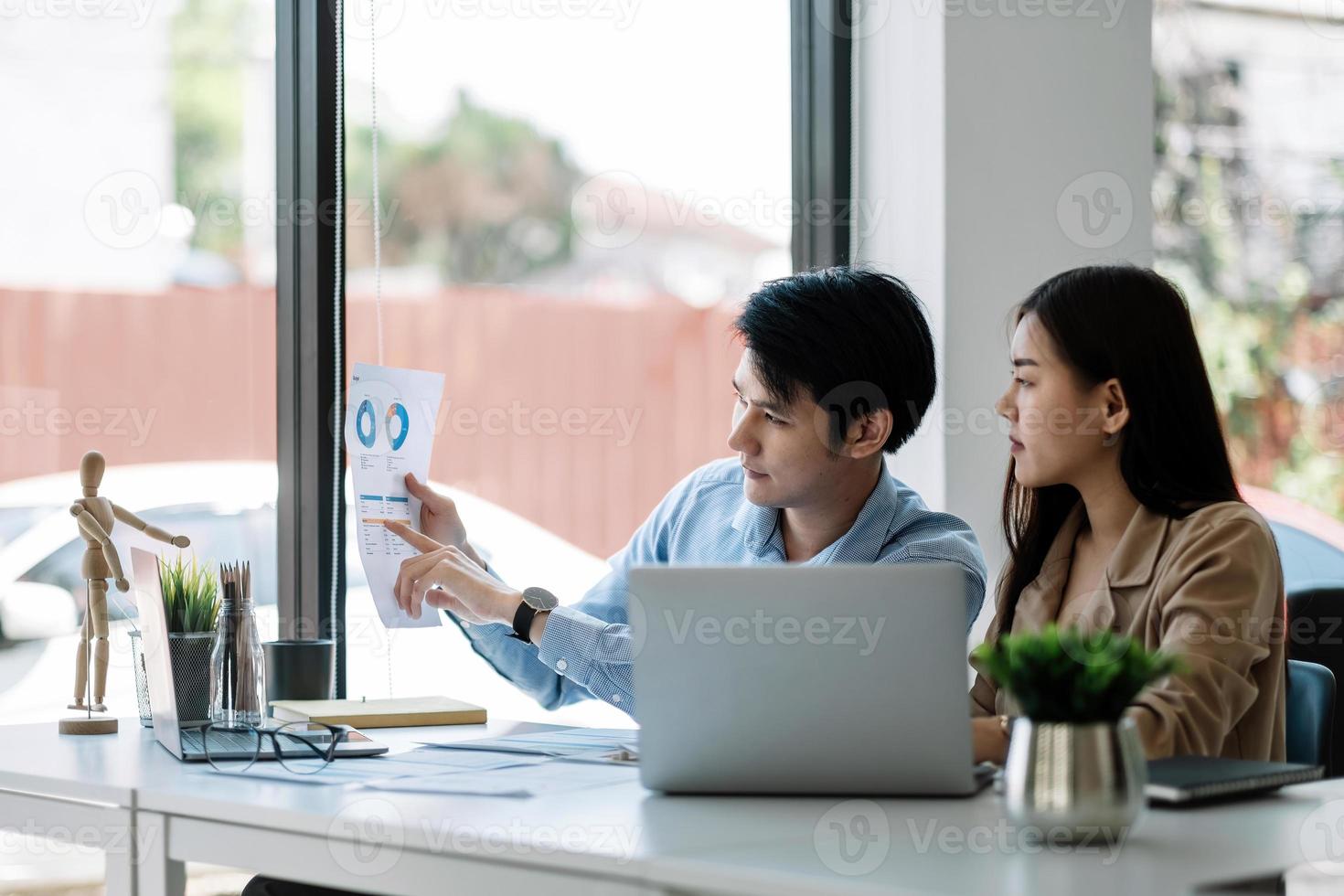Two business asian data dashboard analysis. Investment application display business sales and profit on paperwork and advise marketing planning decision. photo