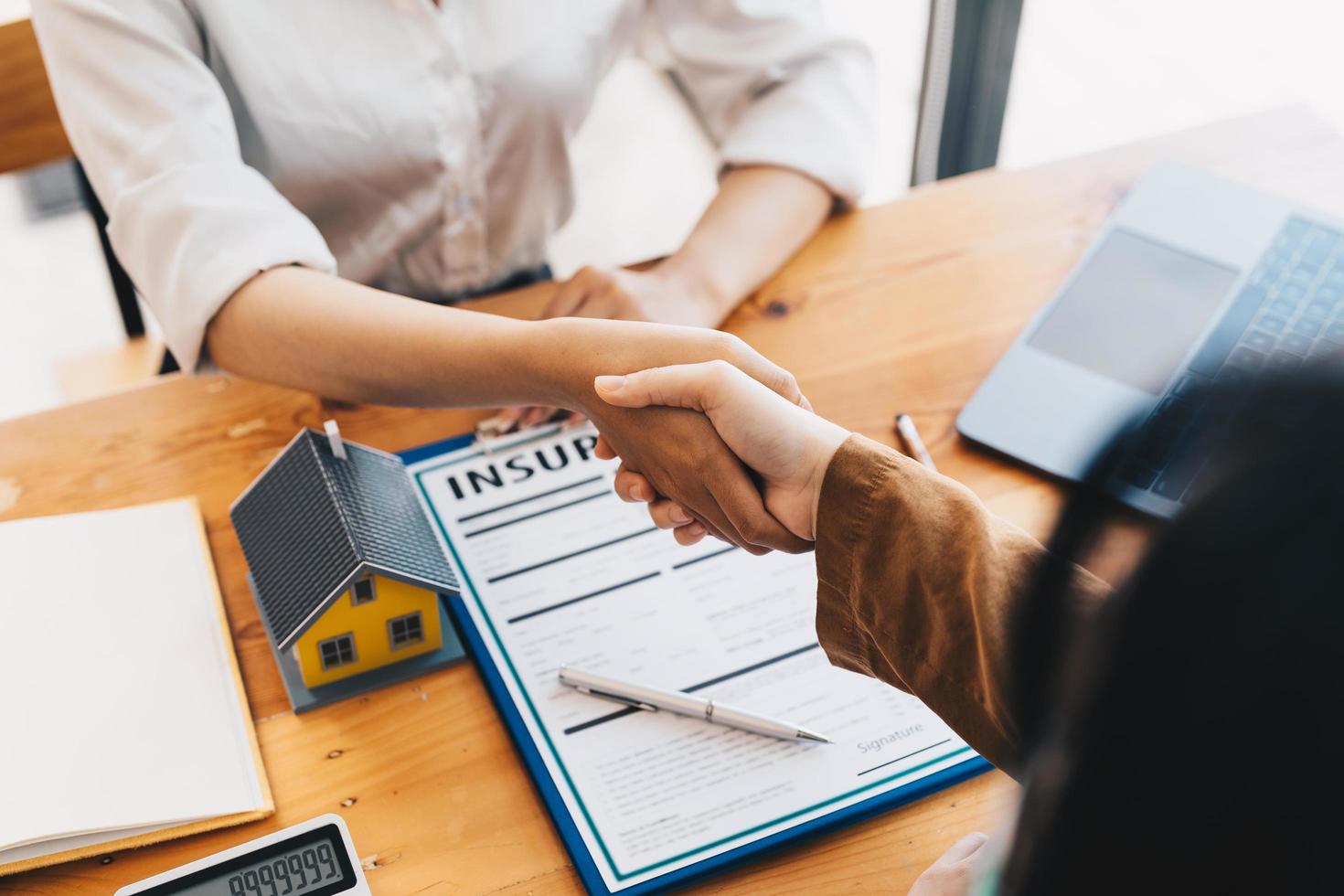 Successful agreement , estate,home buying contract concept, buyer shaking hand with bank empoyees after finishing signing contract in office photo