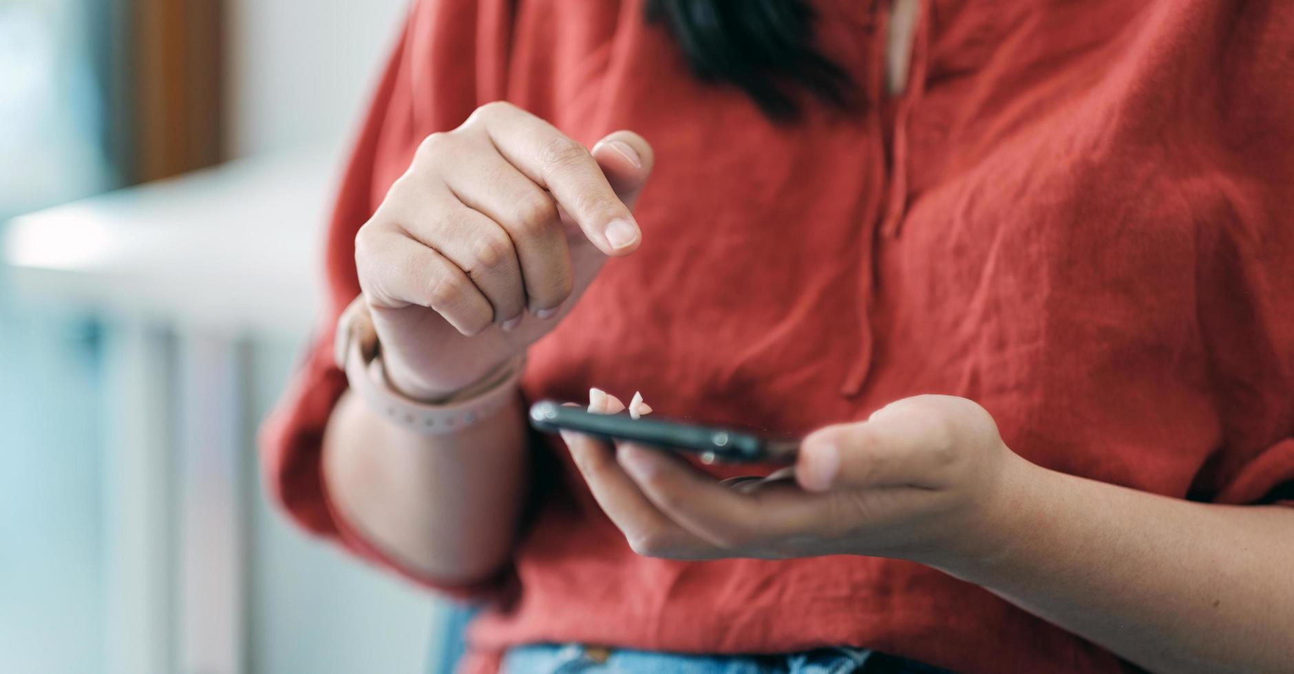 Close up woman using smart phone with hand finger touch screen, texting, chatting or social media photo