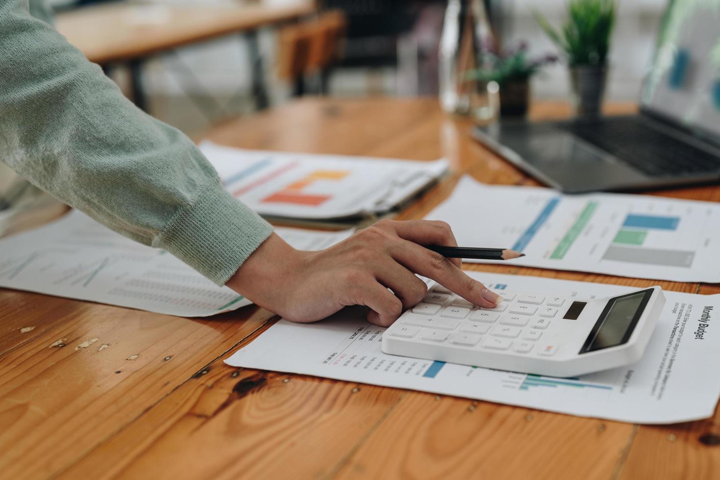 Close up business woman using calculator for do math finance in office and business working background, tax, accounting, statistics and analytic research concept photo