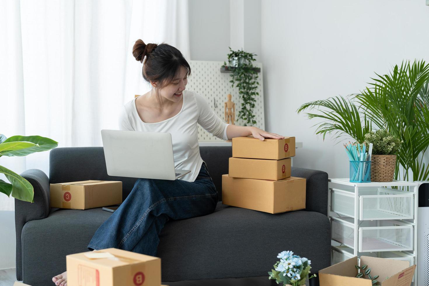 Starting Small business entrepreneur SME freelance, Portrait young woman working at home office, box,,laptop, online, marketing, packaging, delivery, SME, e-commerce concept photo