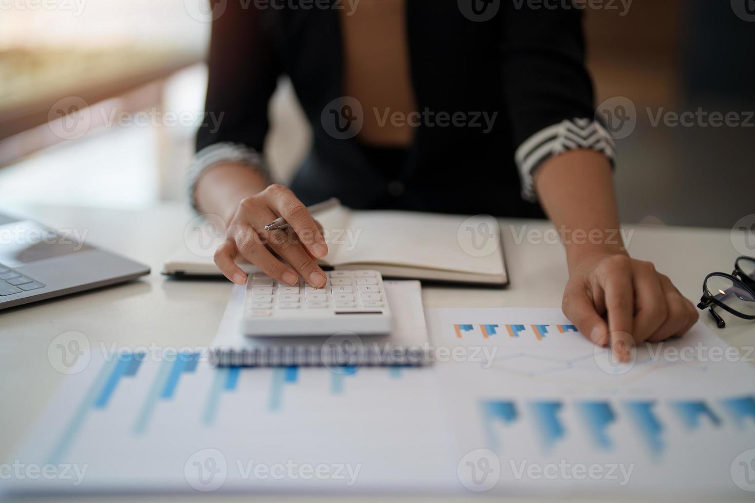 Businesswoman accountant or financial expert analyze business report graph and finance chart at corporate office. Concept of finance economy, banking business and stock market research. photo