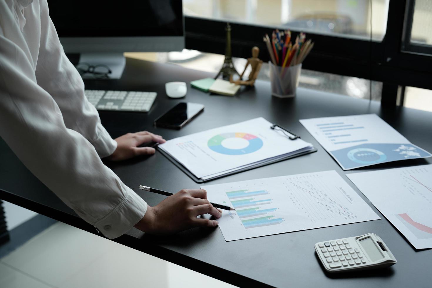 Business woman using calculator for do math finance on wooden desk in office and business working background, tax, accounting, statistics and analytic research concept photo