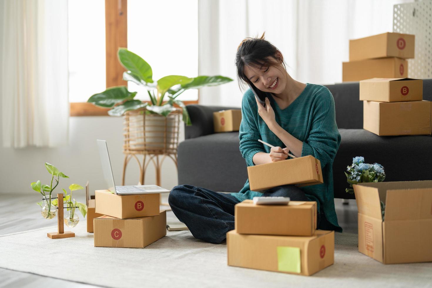 Starting Small business entrepreneur freelance, Portrait young woman working at home office, BOX, smartphone, laptop, online, marketing, packaging, delivery, b2b, SME, e-commerce concept photo