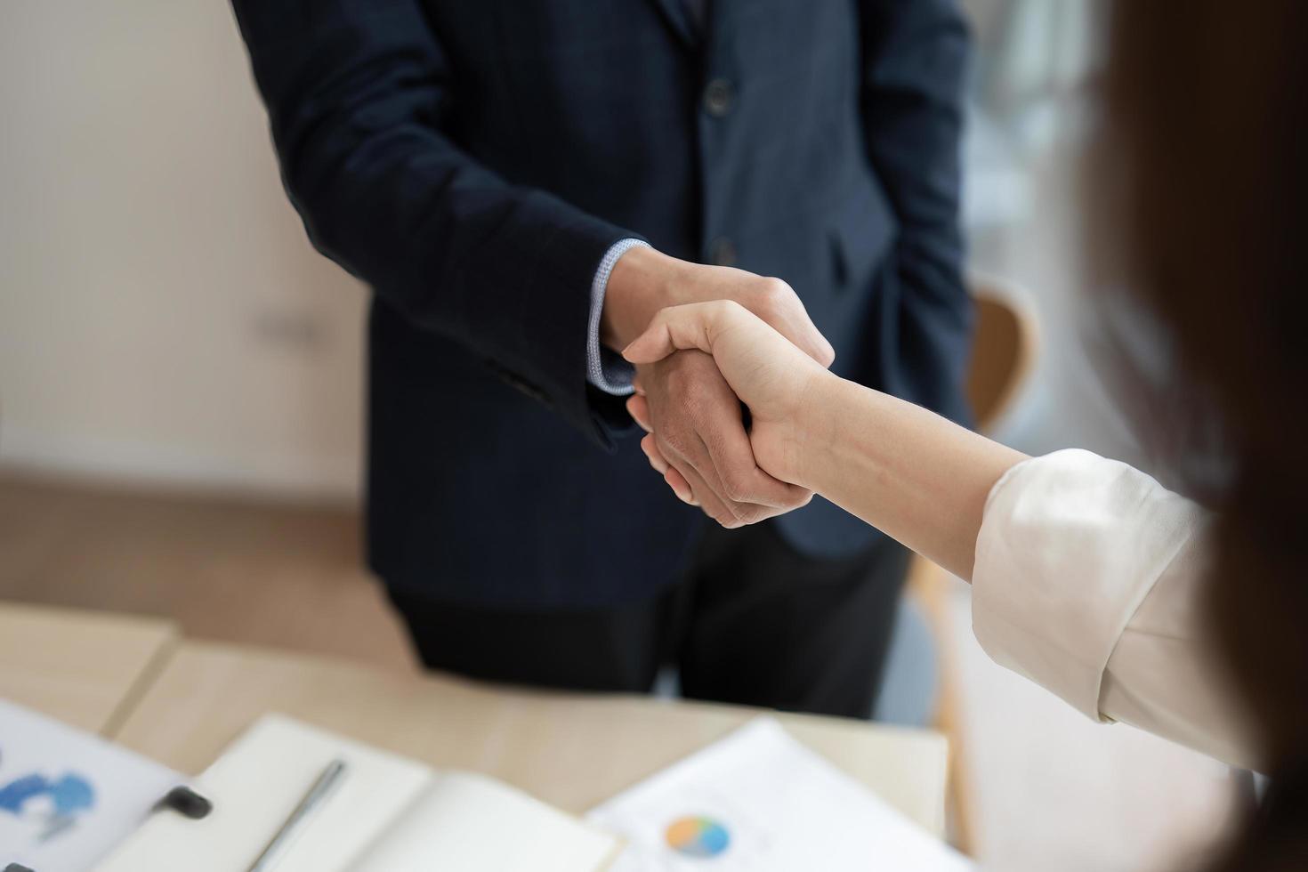 Business asian agreement and successful negotiation concept, businessman in suit shake hand with customer, client after formal communication and contract deal success photo