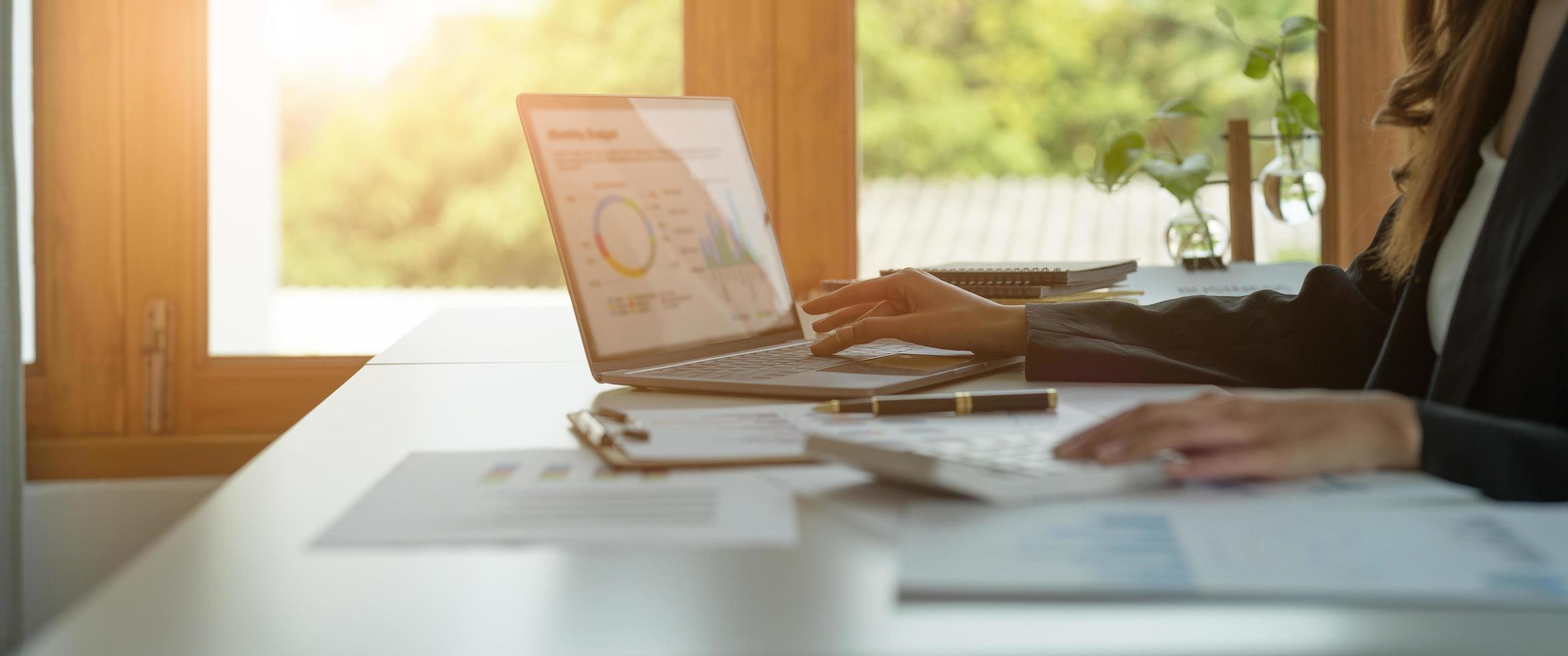 Business woman calculating domestic expenses involved in financial paperwork indoors, focused lady managing monthly banking payments summarizing utility bills and taxes at home photo