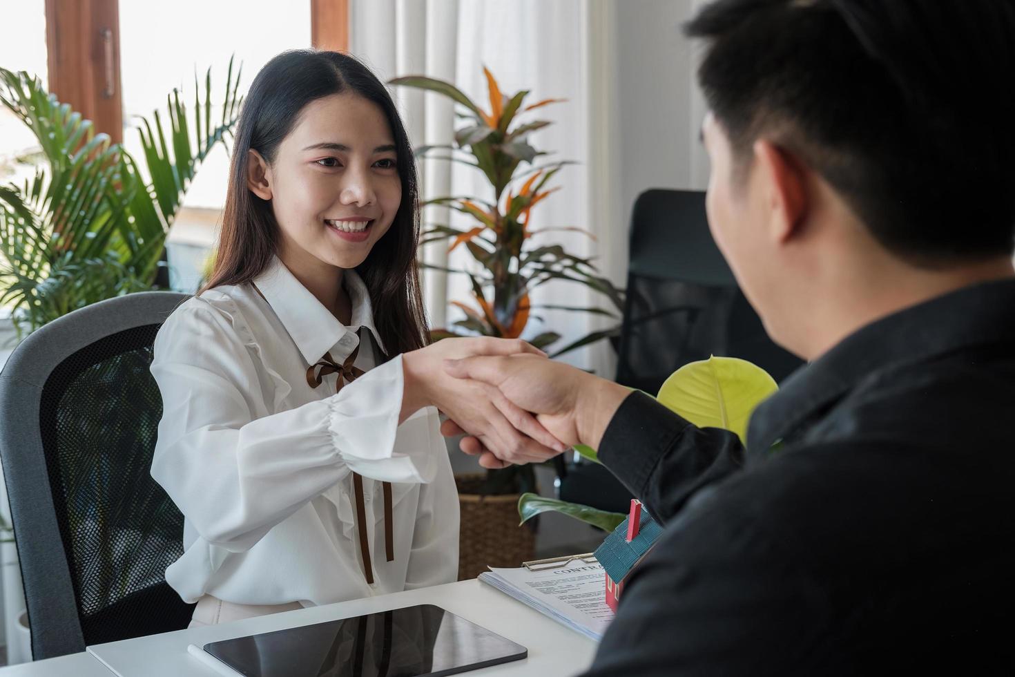 Business people handshake for teamwork of business merger and acquisition, successful negotiate, hand shake, two asian business people shake hand with partner to celebration partnership photo