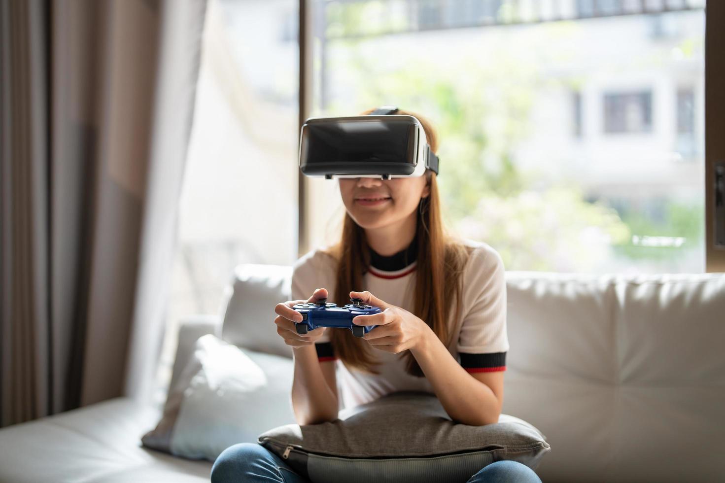 close up happy emotion asian woman playing video games with controller on abstract background toned with virtual glasses photo