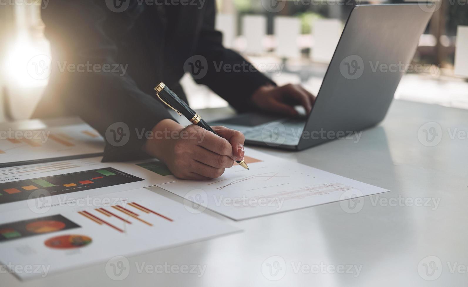Financial businesswoman calculating corporate income tax data And analyzing charts of financial stocks that are in good condition with growth and progress, Investment in finance and accounting photo