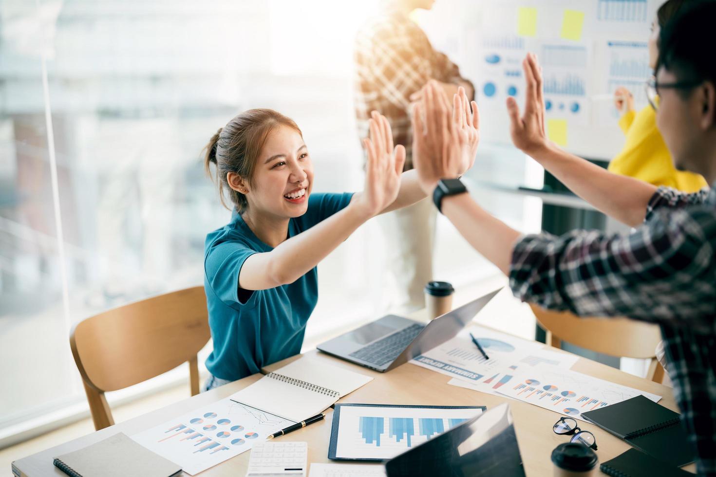 Multiracial young creative people in modern office. Group of young business people are working together with laptop, tablet, notebook. Successful hipster team in coworking. Freelancers photo