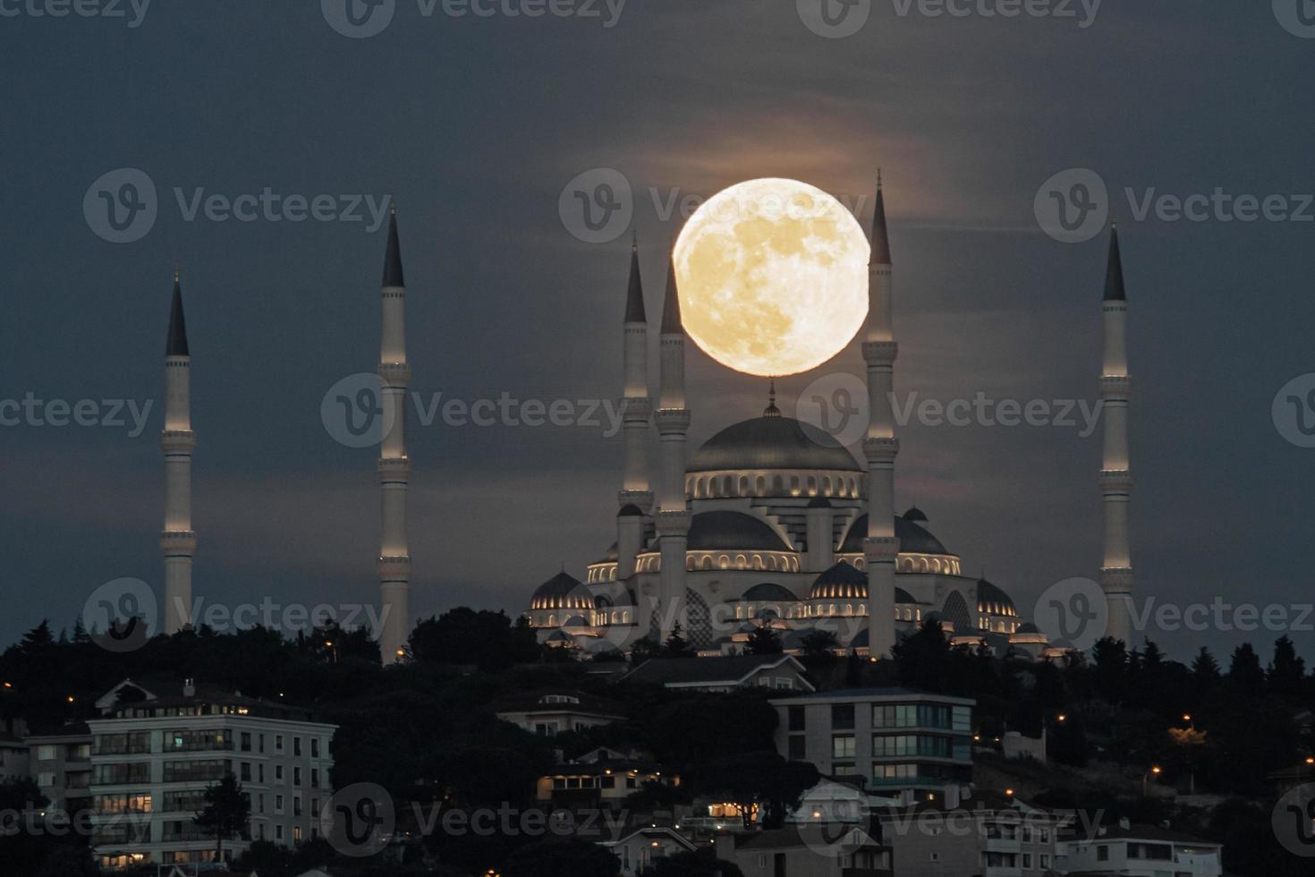 Moonrise over Camlica Mosque in Istanbul, Turkey photo
