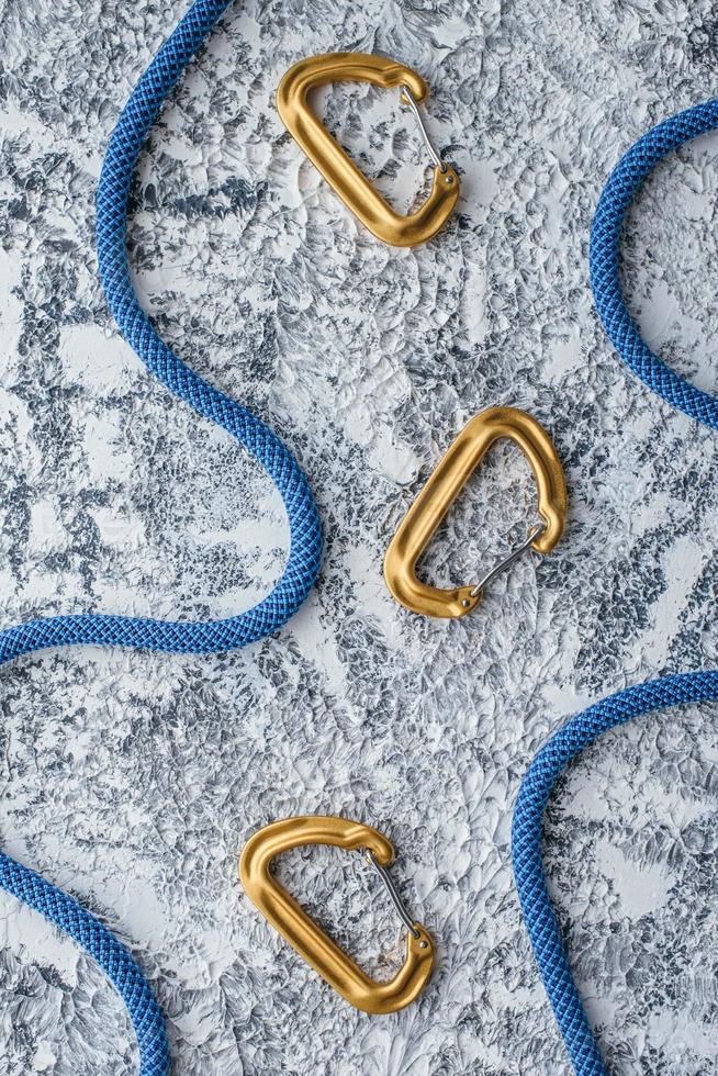 Captured at daytime. Natural lighting. Isolated photo of climbing equipment. Part of carabiner lying on the white and grey colored table