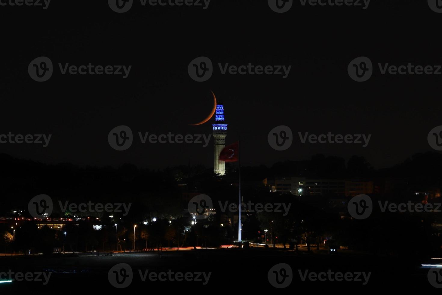 Moonset over Beyazit Tower, Istanbul, Turkey photo