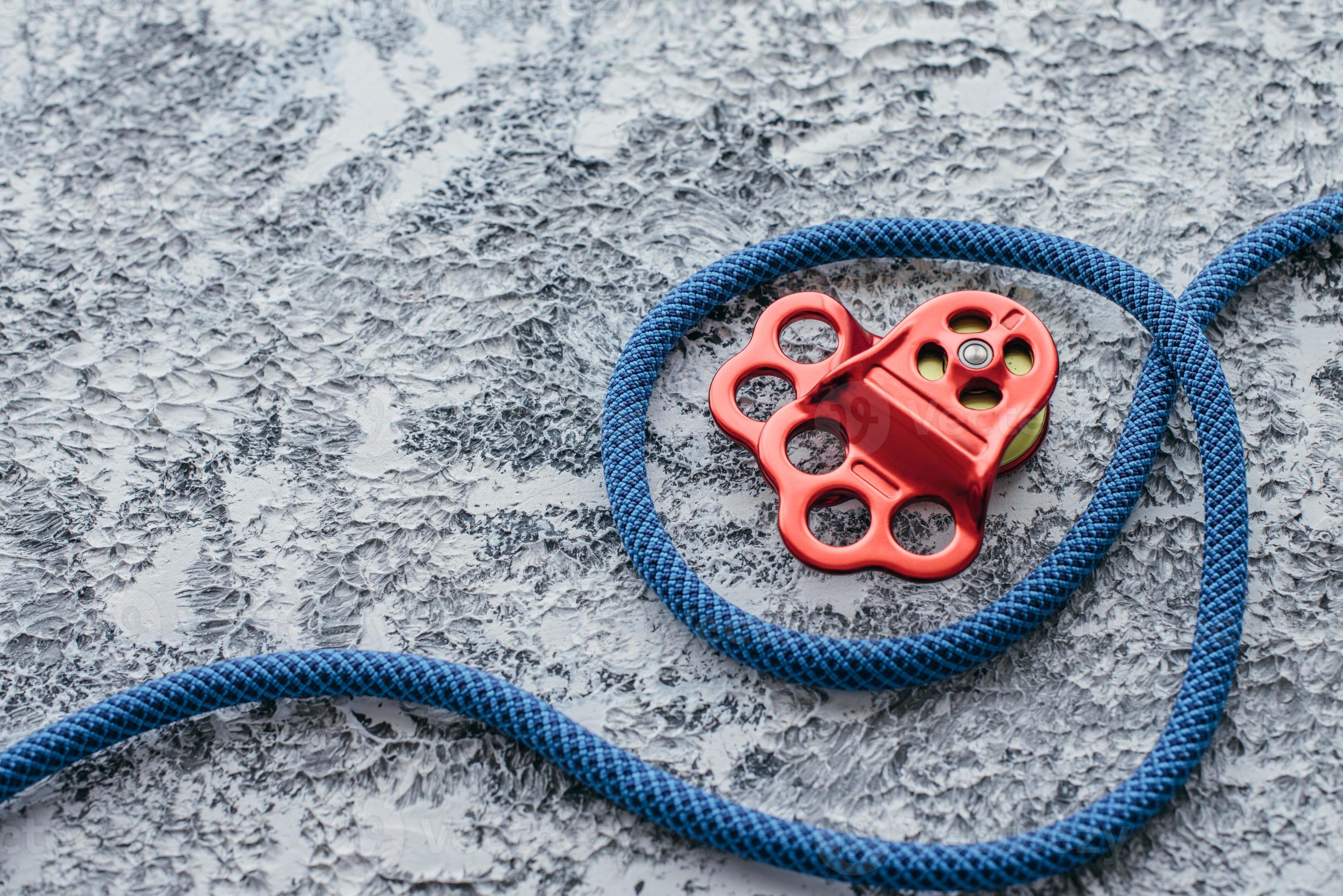 Hiking rope. Isolated photo of climbing equipment. Part of carabiner lying  on the white and grey colored table 8575497 Stock Photo at Vecteezy